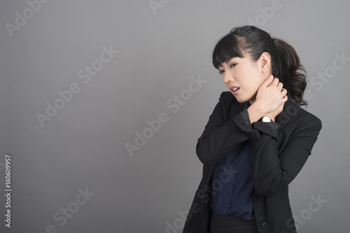 Business Woman Neck pain on grey background