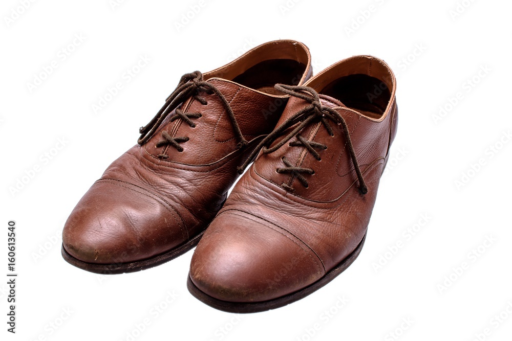 Old brown shoes on an isolated white background