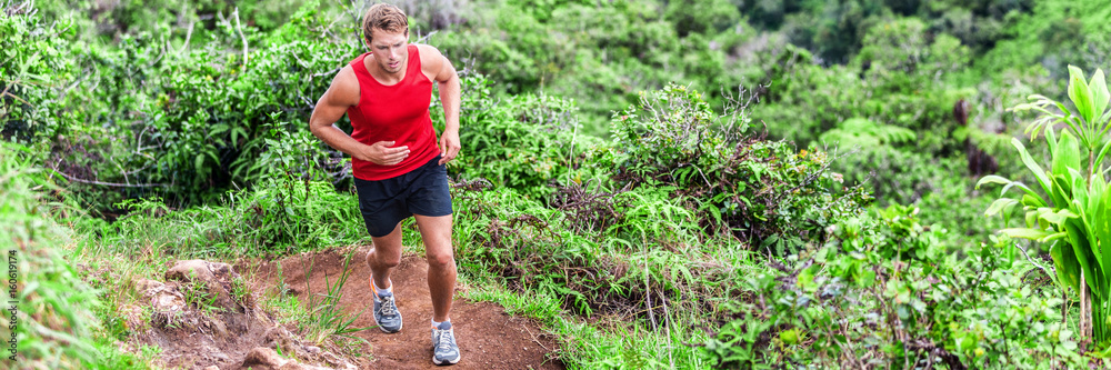 Trail running man athlete on marathon race banner. Panorama crop of runner in forest green nature. Trail running man athlete on marathon race banner. Panorama crop of runner in forest green nature.