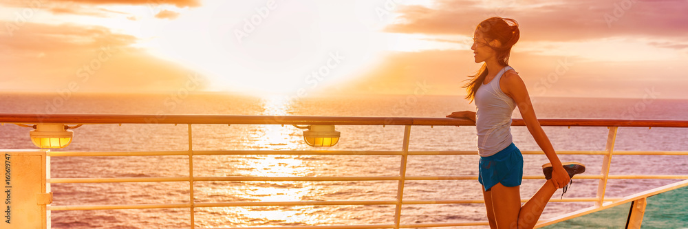 Fototapeta premium Cruise ship vacation healthy active running lifestyle. Fitness runner woman stretching leg warm-up before exercise on outdoor deck of cruise ship boat. Woman enjoying Caribbean holiday.