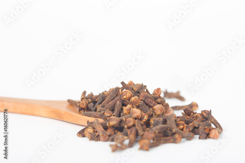 Wallpaper Mural Dry cloves in wooden spoon on white background. Cloves help in improving the immune system. Torontodigital.ca