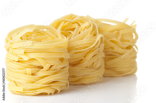 Tagliatelle eggs isolated on white, focus is on the first