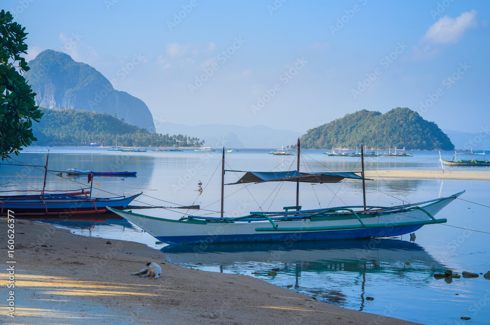 Traditional banca boat at sandy Corong Beach in El Nido, Philippines