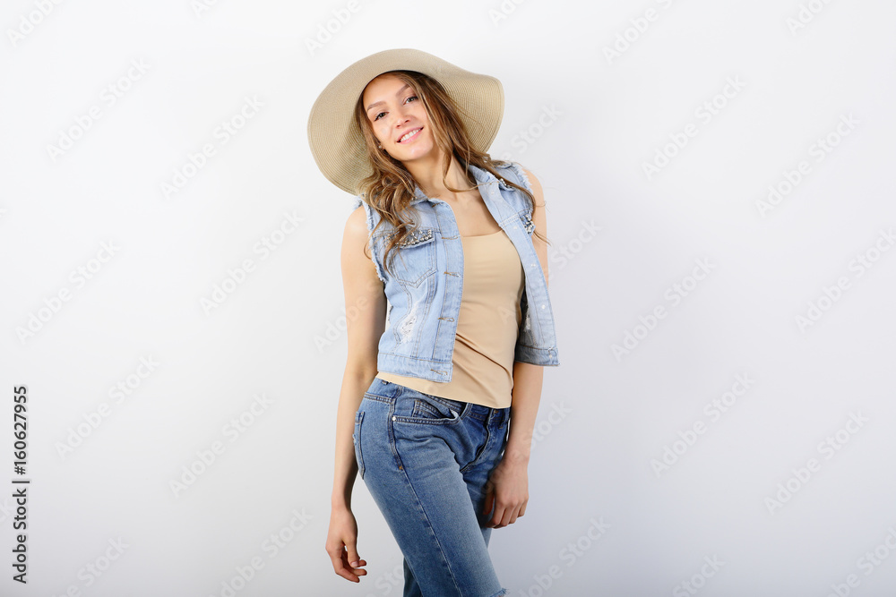 Beautiful summer woman in straw hat, jeans vest on white background Beautiful summer woman in straw hat, jeans vest on white background