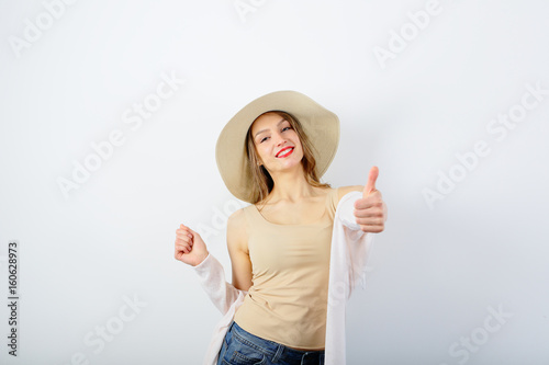 Positive woman with thumbs up, on white background photo