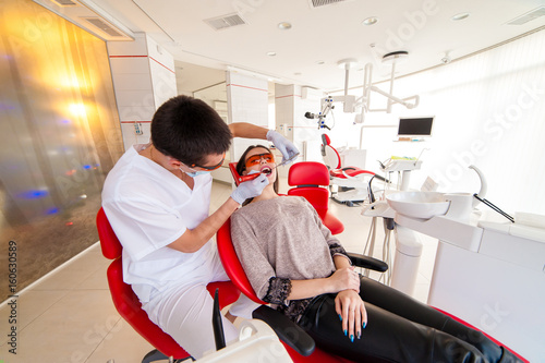 Dentist puts the seal of a beautiful girl.