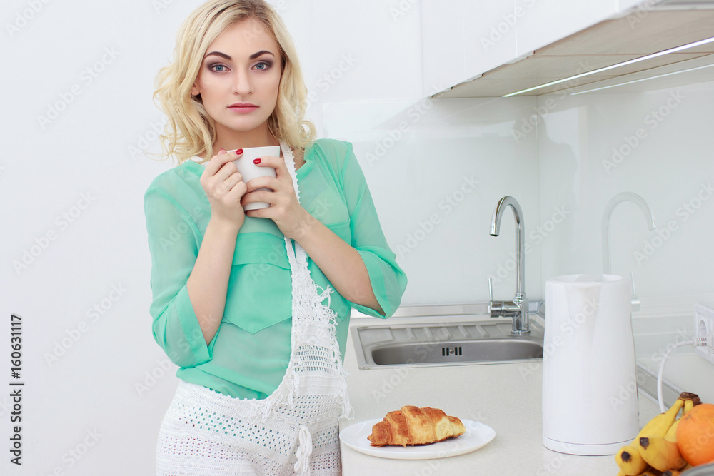 Young smiling woman having breakfast.Morning ritual Young smiling woman having breakfast.Morning ritual