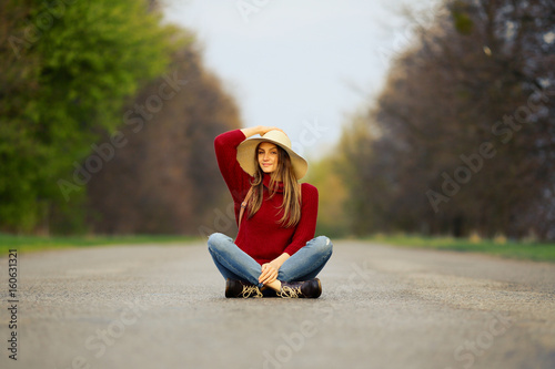 Girl on freedom way, sitting on road nature, natural background