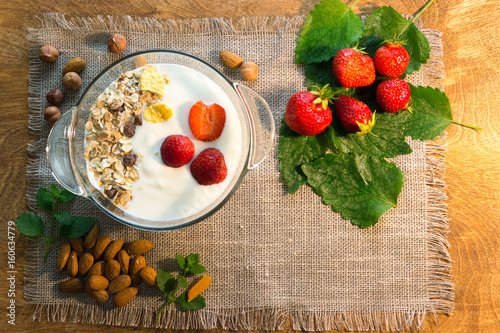 Yoghurt and muesli with nuts and strawberries for Breakfast. Healthy eating.