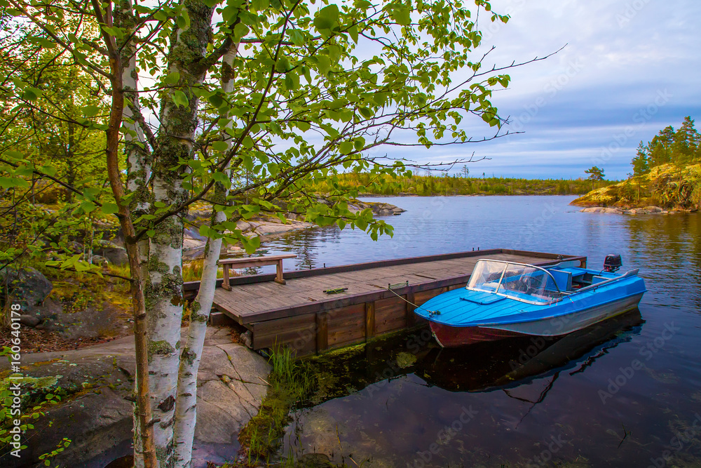 Boat at the pier. Motor boat at the pier. Karelia. Ladoga lake.