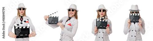 Beautiful girl in striped clothing holding clapperboard isolated