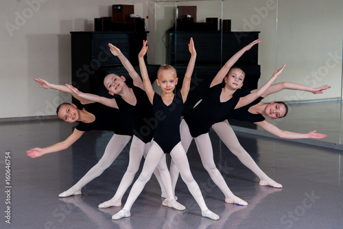 The choreographer teaches children dances. photo