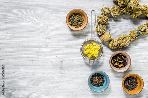 Different kinds of herbal tea on wooden background top view mockup