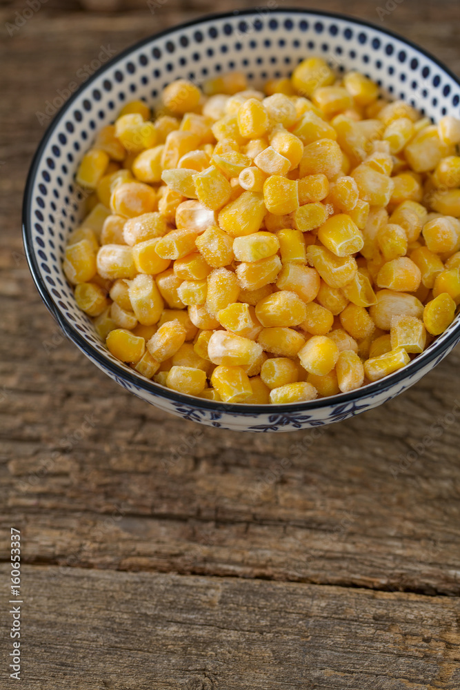 frozen sweet corn on woode surface