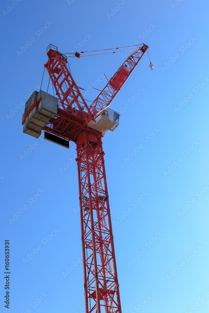 Tower crane against blue sky, UK. Tower crane against blue sky, UK.