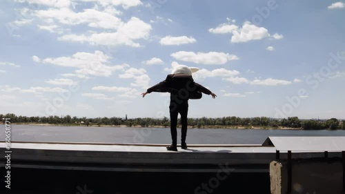 A man in a hare on the roof. Rabbit on the roof. Leap from the roof.