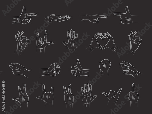 Different outline hands gestures in chalk on blackboard