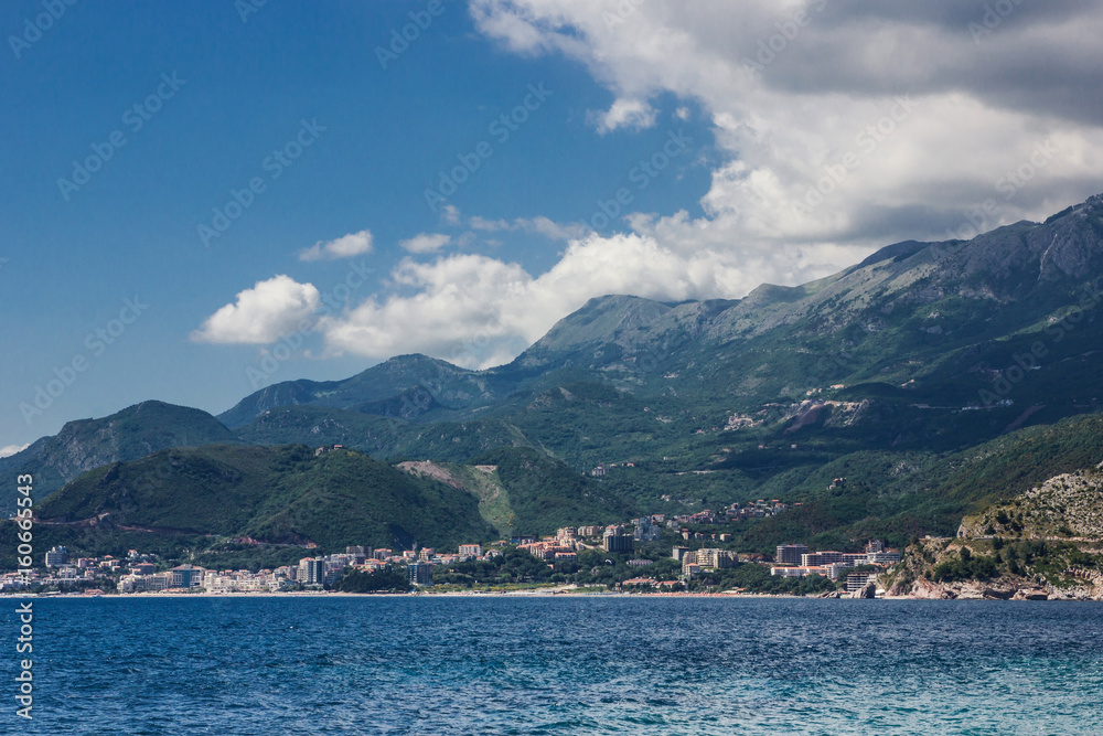 Obraz premium Montenegro sea shore with mountains and blue cloudy sky landscape.