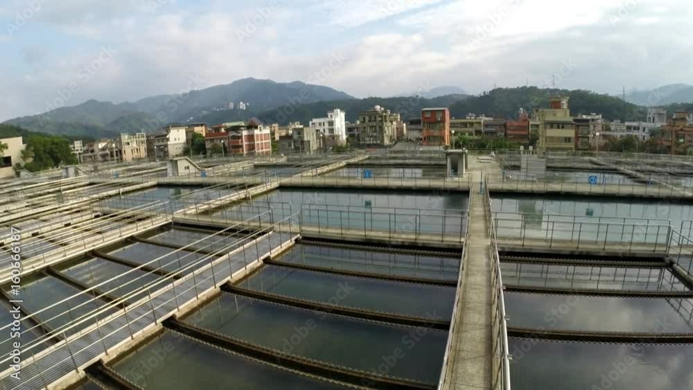 Taipei, Taiwan-05 December, 2015: Aerial view of water treatment facility located in Taipei, northern Taiwan. There are mountains on the horizon and vegetation around.