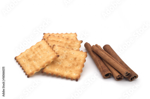 Crackers and cinnamon sticks on a white background