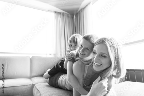 young mother spending time with kids on the floor