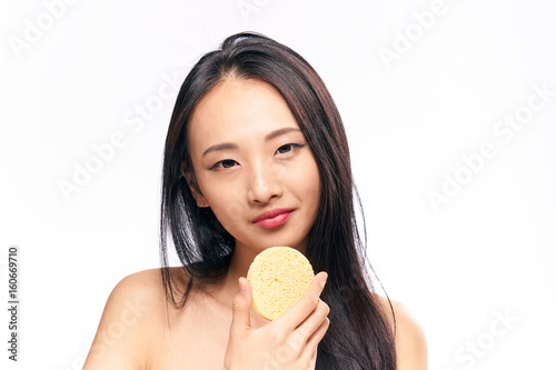 Face care, woman with sponge on isolated background portrait