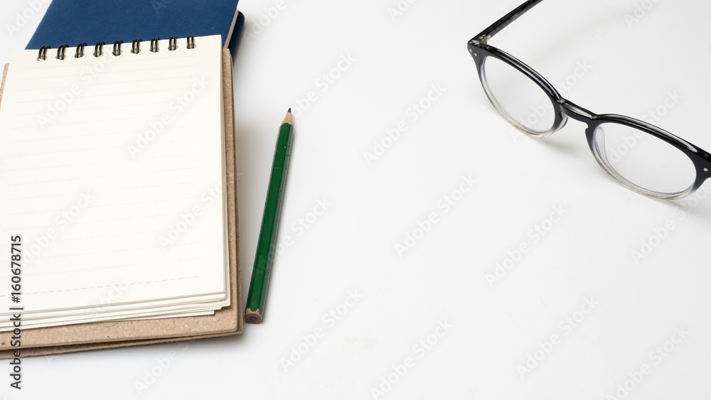 Office desk table notebook and pencil close up on white background Office desk table notebook and pencil close up on white background