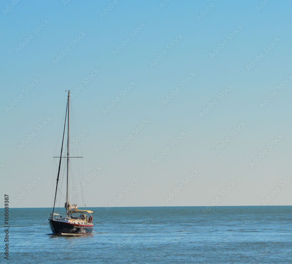 A sail boat on the Gulf of Mexico heading toward Johns Pass in Florida. A sail boat on the Gulf of Mexico heading toward Johns Pass in Florida.