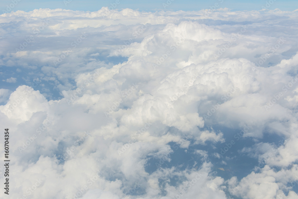 Blue sky and Clouds as seen through window of aircraft Blue sky and Clouds as seen through window of aircraft