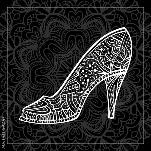 Glamour white tracery high heel shoe on a dark background