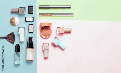 Fototapeta Naklejka Na Ścianę i Meble -  Creative flat lay of fashion bright nail polishes and decorative cosmetic on a colorful background. Minimal style. Copy space. Beauty blogger concept. Top view