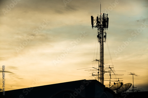 silhouette mobile antenna tower, or silhouette telephone communication tower,...
