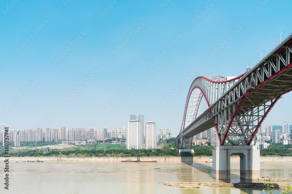 steel bridge over river in modern city