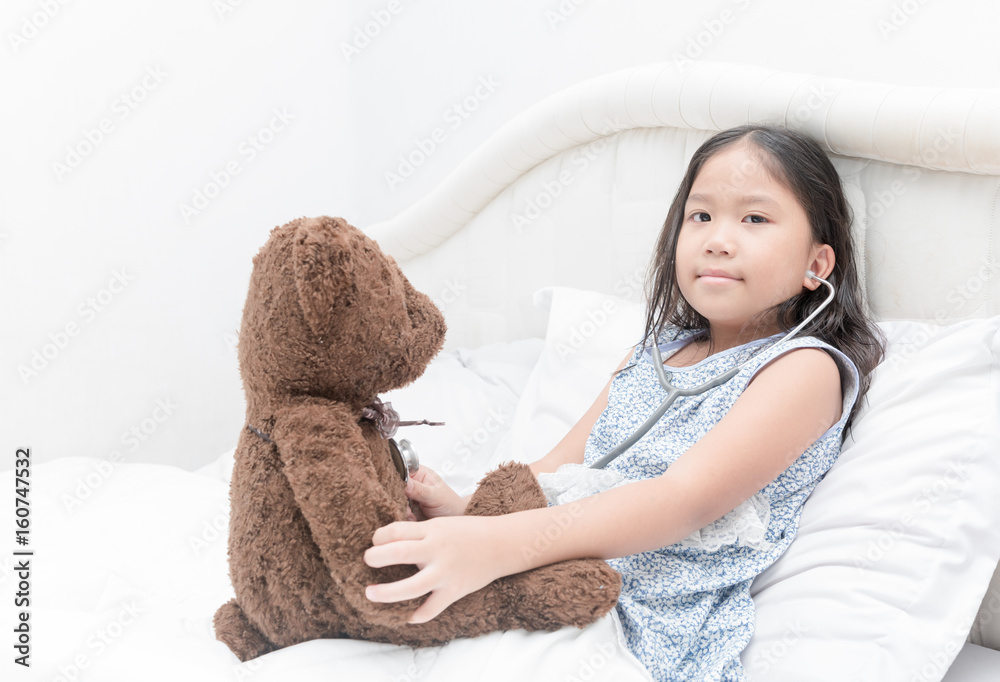 kid or child playing doctor with stethoscope and teddy bear kid or child playing doctor with stethoscope and teddy bear