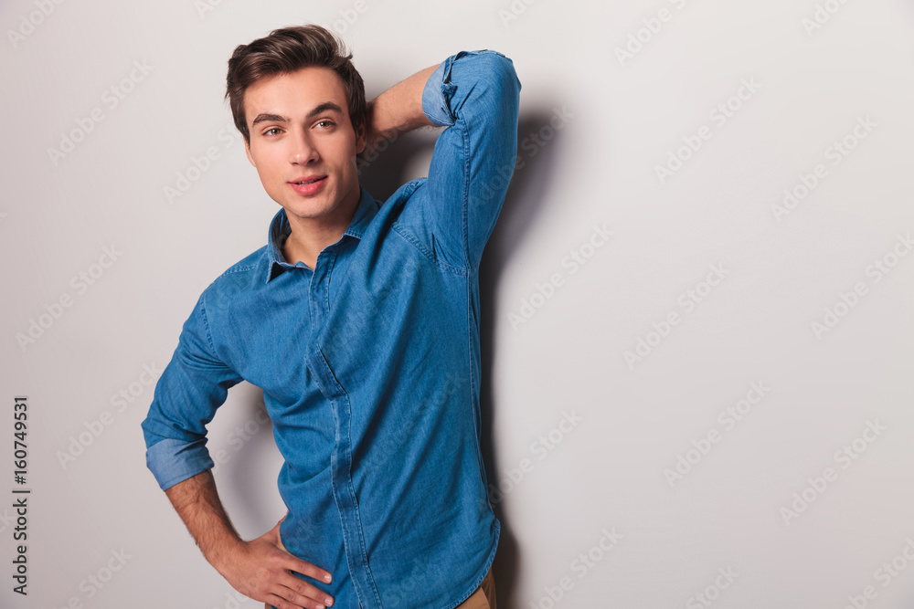 casual young man posing and looks to side casual young man posing and looks to side