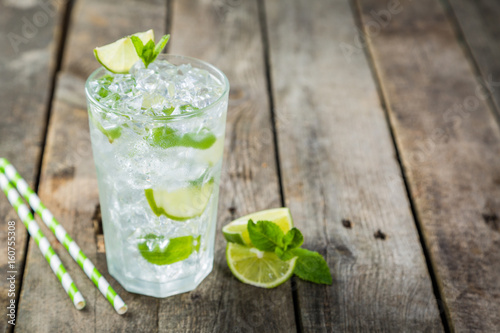 Mojito in glass on rustic wood background