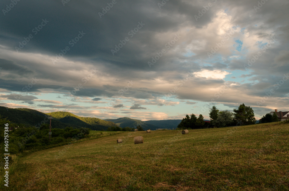 Fototapeta premium Cloudy sunny landscape scene in nature in the summer while hiking 