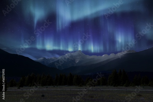 Amazing northren lights (aurora borealis) over the rocky mountains photo