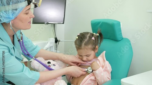 Happy child at doctor's reception, consultation of ENT doctor, otoscopy, advice otolaryngologist in clinic, treatment of ENT diseases in children, Medical procedure, otolaryngologist treats infant