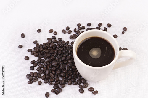 Coffee cup and beans on white background.