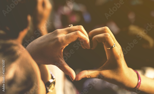 hand heart symbol with blur background on warm tone
