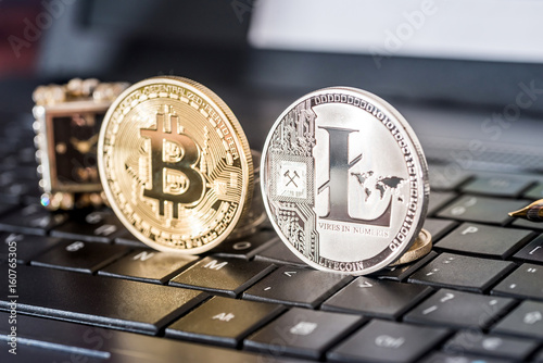 bitcoin and litecoin on black laptop keyboard photo
