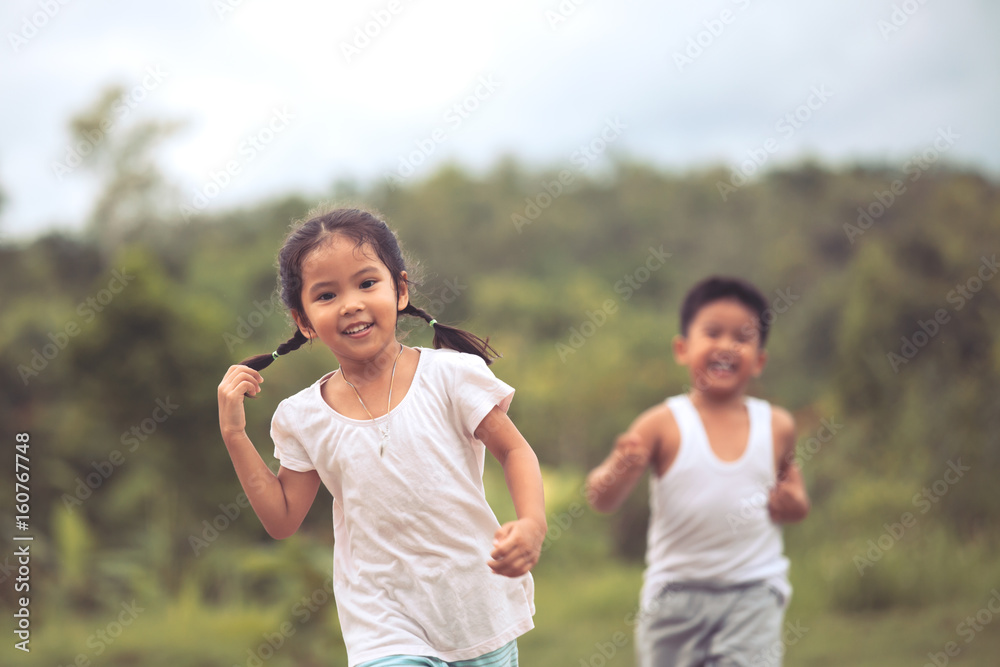 Cute asian little girl having fun to run and play with her friend in ...
