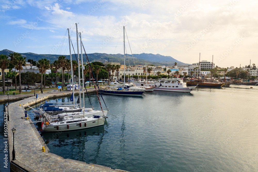 Fototapeta premium Yacht marina and ferries terminal of Kos town in greece islands of aegean sea. View from above on turquoise water surface of Kos port.