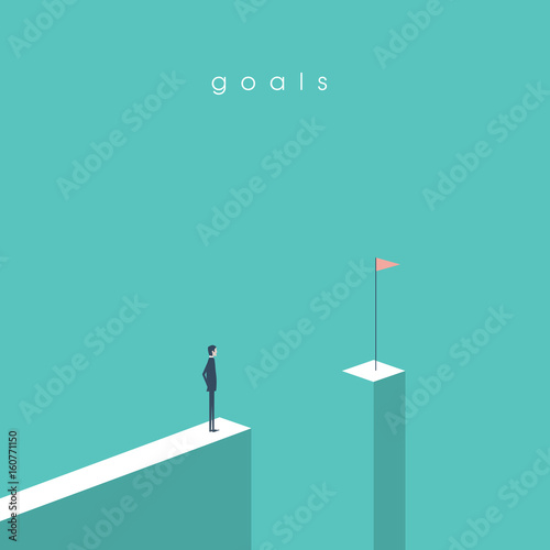 Businessman standing in front of gap looking at flag. Business concept of goals, success, achievement and challenge.