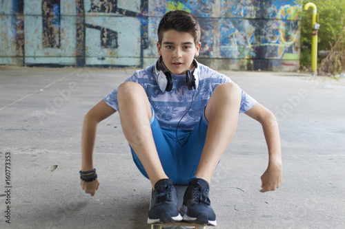 child with skateboarding in the city photo