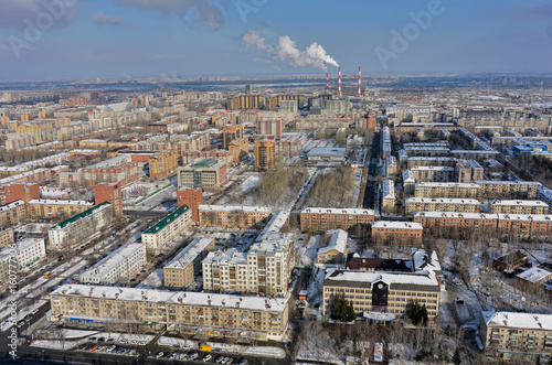 Tyumen, Russia - February 14, 2016: Aerial view onto residential area, office buildings of Sberbank and GEOTEK Seismic exploration with power station on background © Aikon