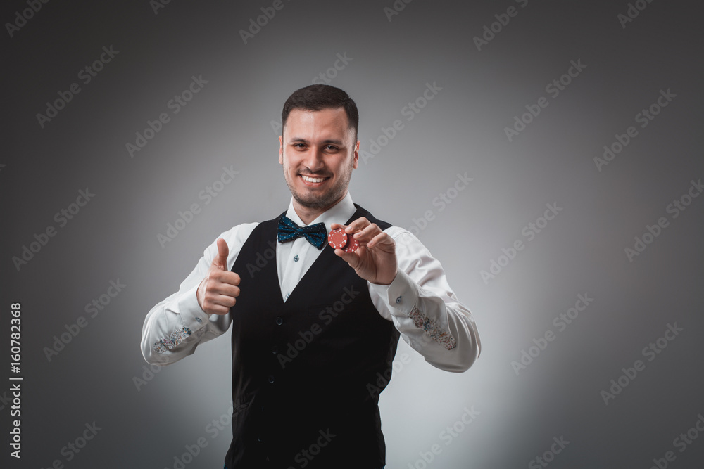 A man holding up red poker chips. Poker A man holding up red poker chips. Poker