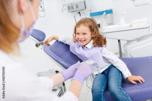 Smiling girl visiting dentist