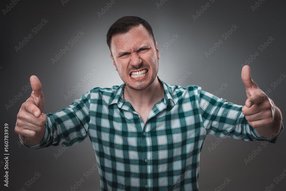 Portrait of excited man looking at the camera and points at you with a finger. Portrait of excited man looking at the camera and points at you with a finger.